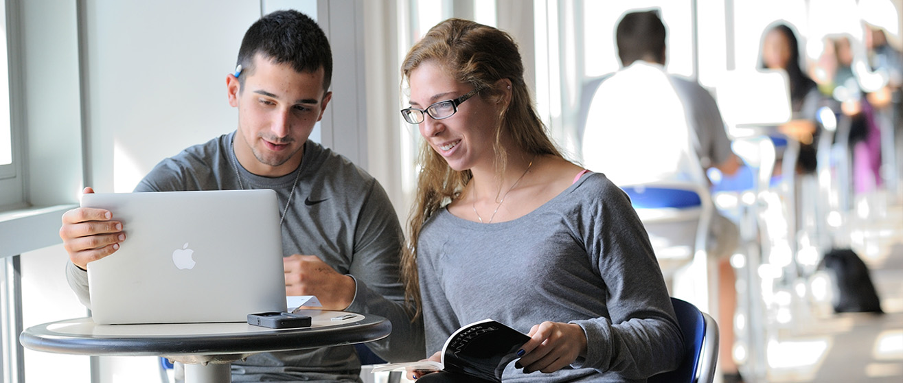 Student smiling in class at the University of Akron