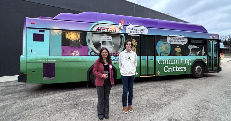 A young man and a woman stnading in front of a city bus