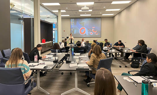 Students in NMGZ taking notes in the Greater Cleveland Partnership board room. The professionals discussed the rebranding of Cleveland.