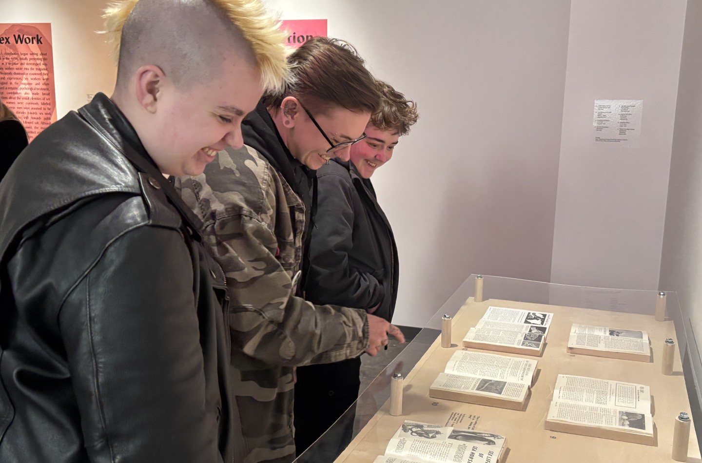 Visitors looking at magazines in a museum display
