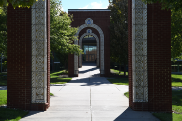 Brick archways lining the walkway into the Student Recreation and Wellness Center.