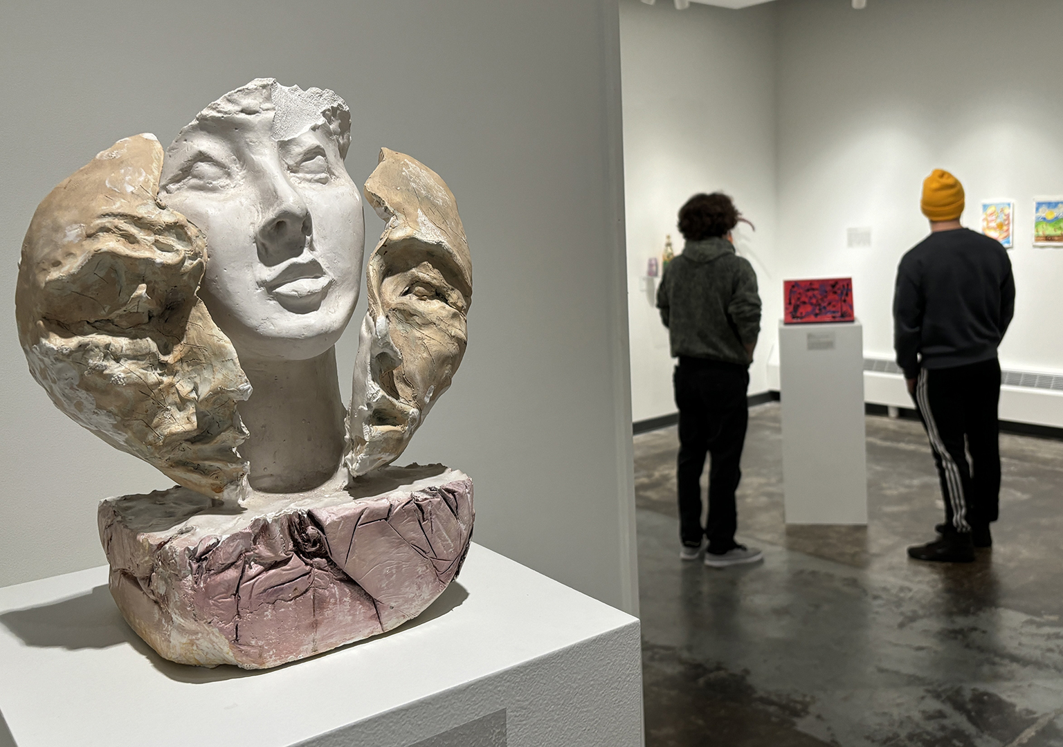 Visitors exploring an art gallery exhibit