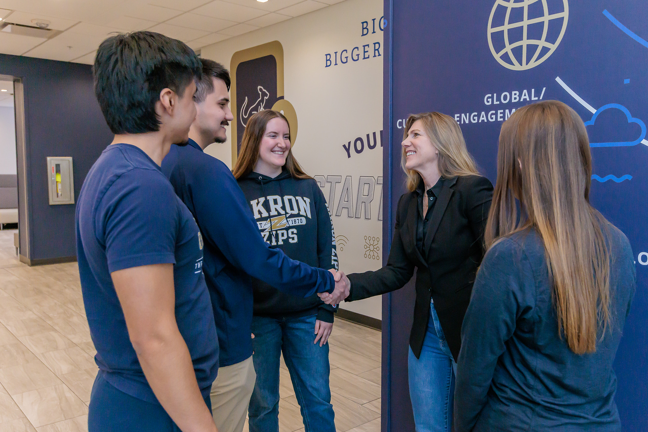 Students and business executive conversing