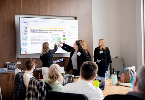 Students collaborating at interactive whiteboard