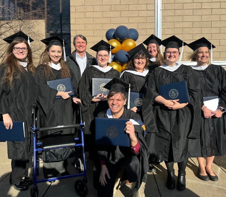 New graduates pose with Prof. Wilson