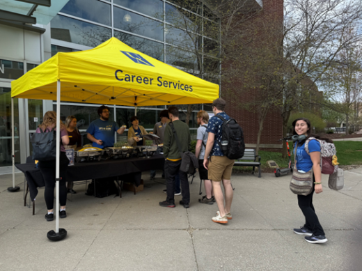 Photo of a Career Chat Pop-Up tent with students talking to Career Services staff