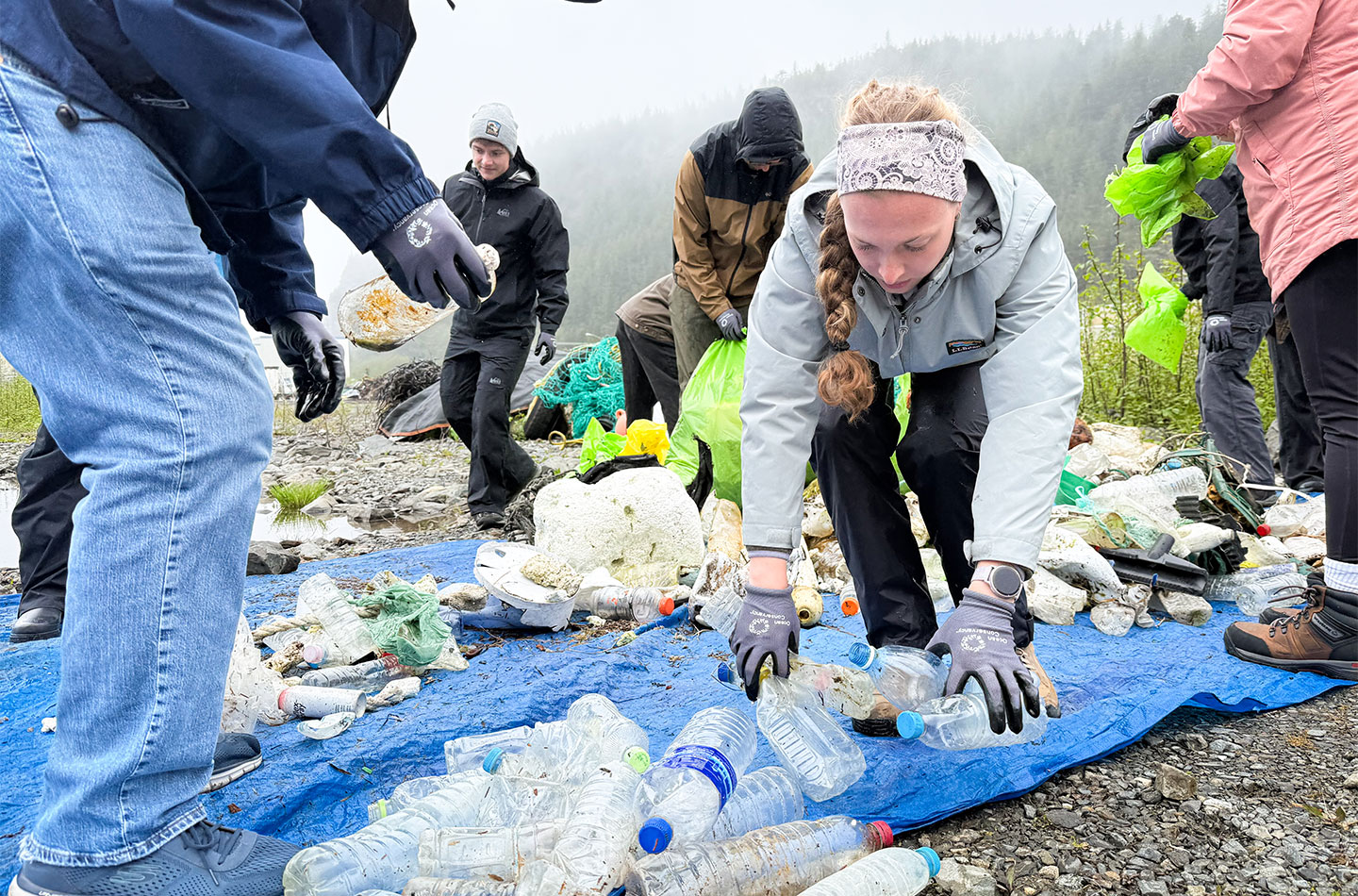 University of Akron students sort plastic bottles and other debris during a community beach cleanup in Sitka, Alaska