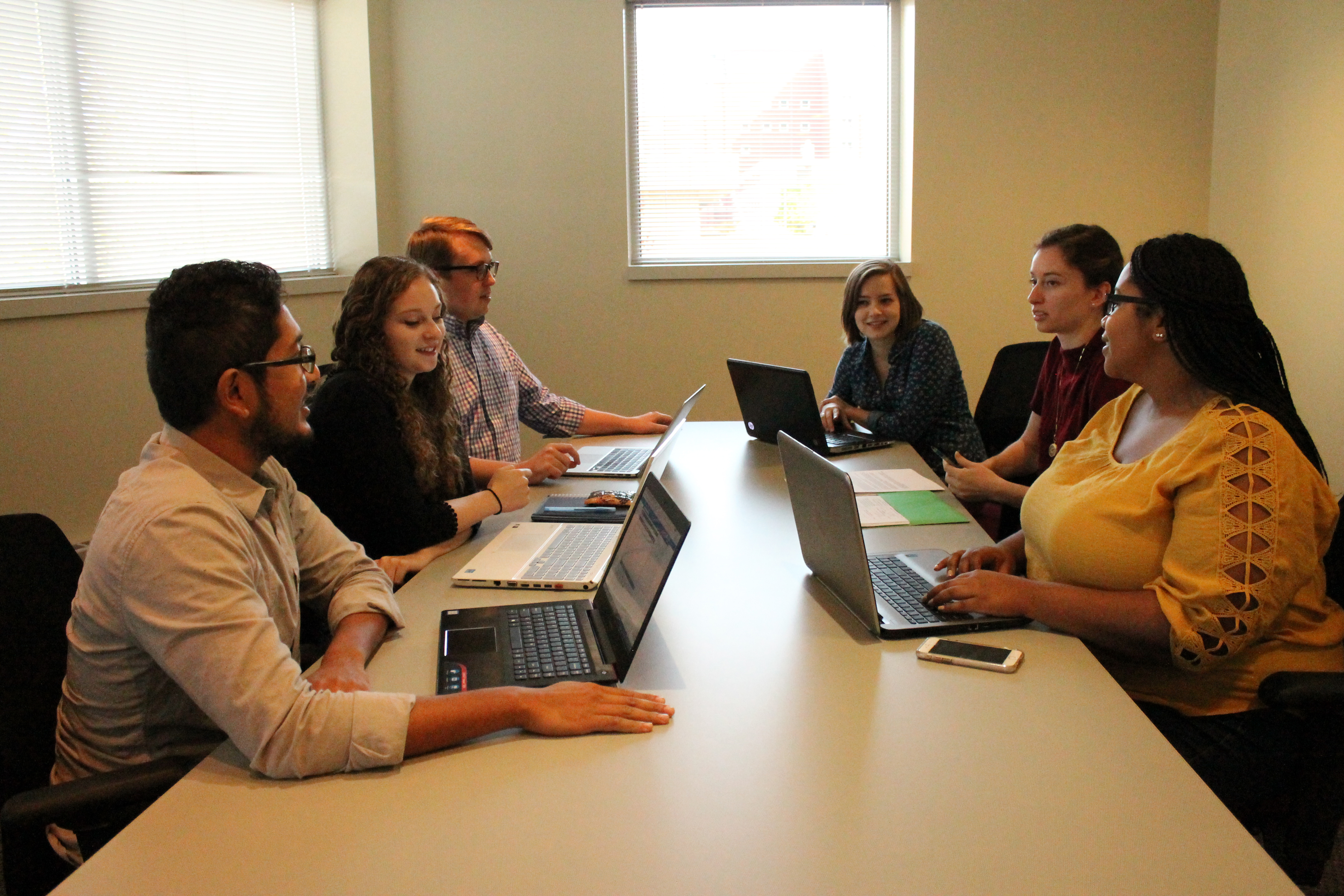 Students at computers at a conference table
