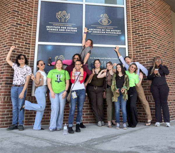 Students posing happily outside the Cummings Center