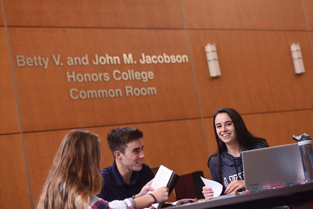 Students hanging out and commiserating in the Williams Honor College Common Room
