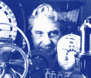 Dr. John Popplestone surrounded by artifacts