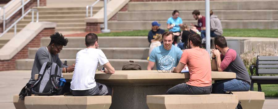 students on UA campus with the mascot Zippy