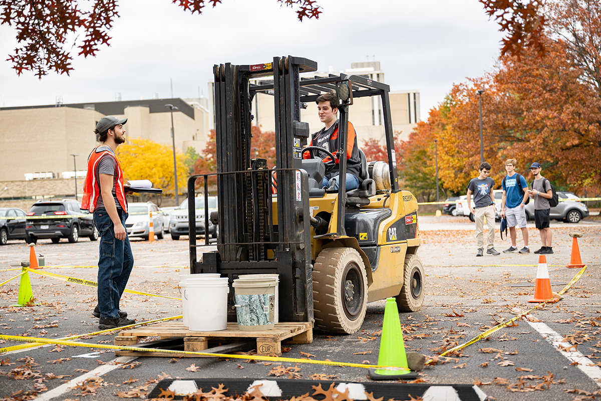 A student competes in the Fork it Over event.