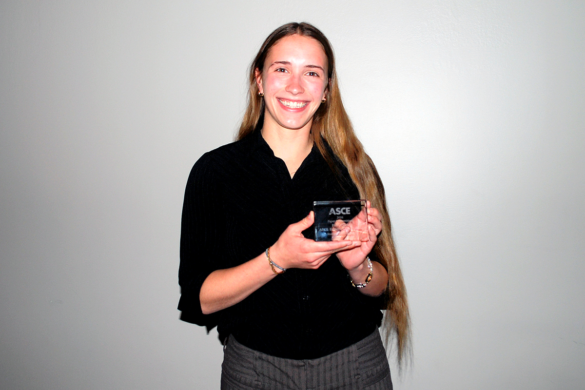 Emma Brutoski displays her first-place award for the Student Symposium Paper competition.