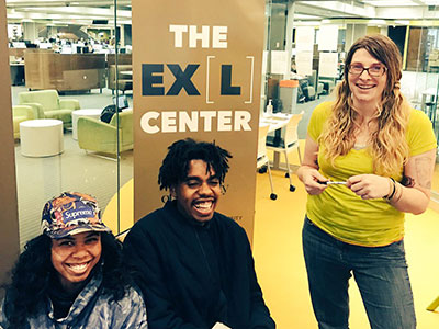 Three students together at the EXL Center located in Bierce Library.