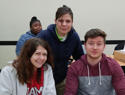 Dr. Pat Millhoff posing with students