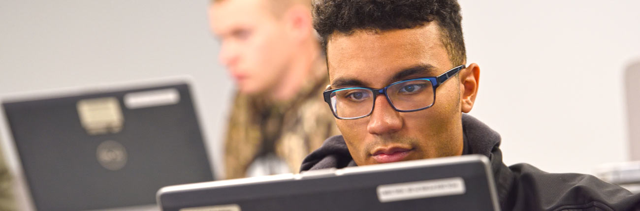 A University of Akron student in a computer lab