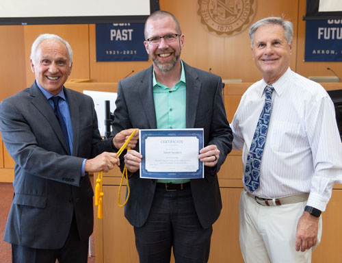 Paul Perantinides (left) and Chris Nolan present the firm’s award to Jason Sanders.