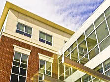 Looking up at the glass and brick facade of the Buchtel College of Arts and Sciences Building, home to the psychology department