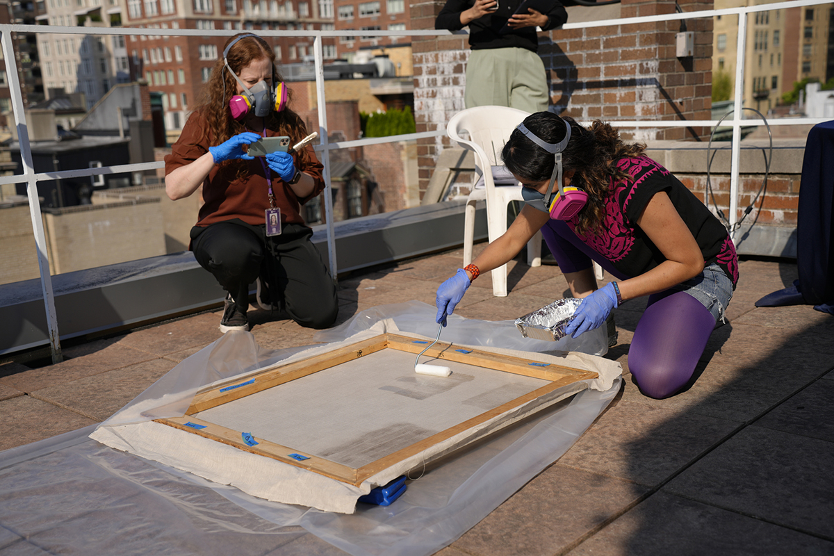 Graduate students at the Conservation Center of NYU’s Institute of Fine Arts test out the new BEVA 371 Akron formulation on the building’s rooftop in Manhattan. Photo by Nita L. Roberts.